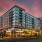 The exterior of Urba Apartments in Ballston, Arlington, VA, featuring a modern facade with large windows and balconies.