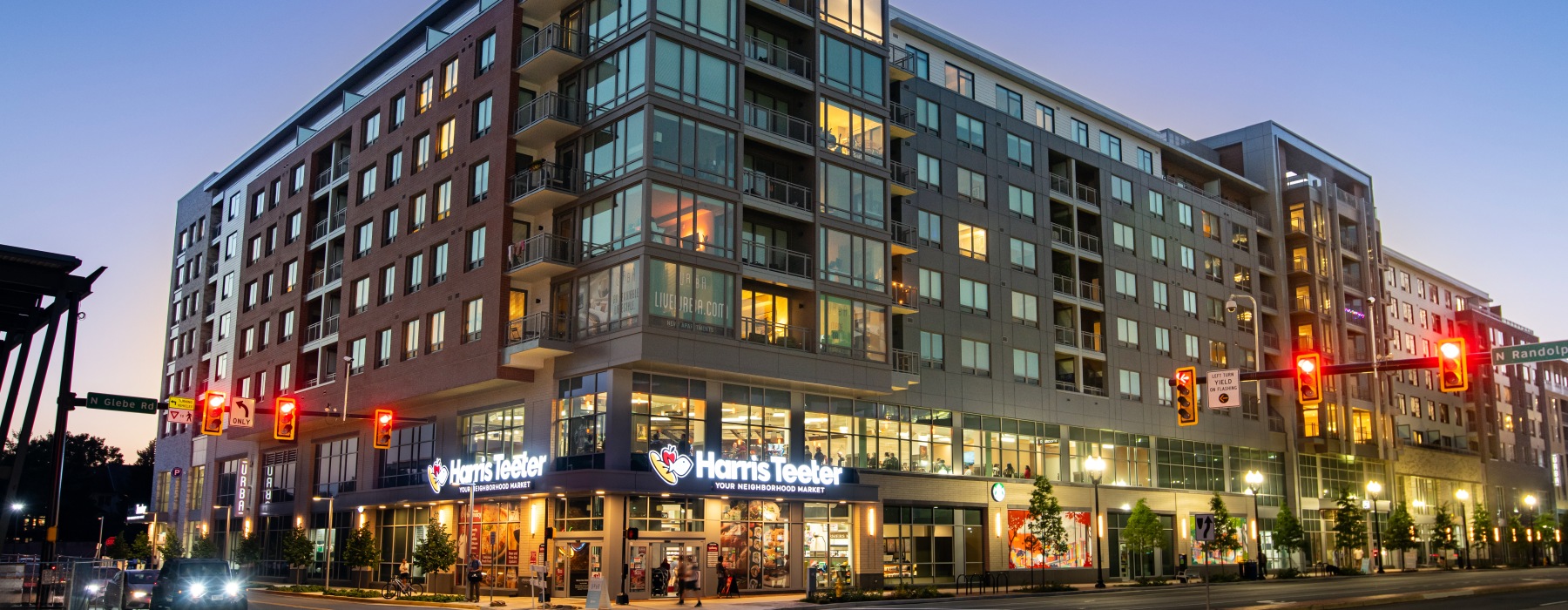 The exterior of Urba Apartments in Ballston, Arlington, VA, featuring a modern facade with large windows and balconies.