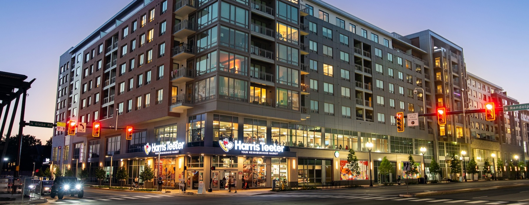 The exterior of Urba Apartments in Ballston, Arlington, VA, featuring a modern facade with large windows and balconies.