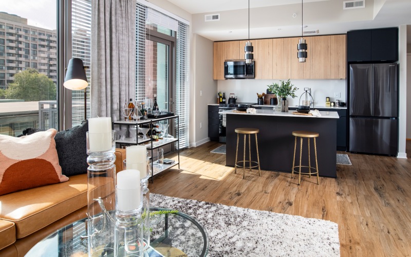 Model kitchen at our apartments for rent in Arlington, VA, featuring wood grain floor paneling and a kitchen island